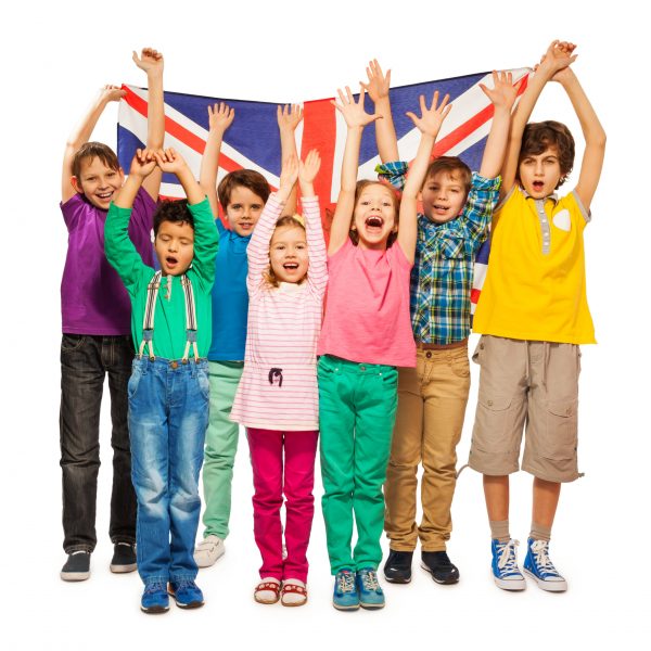 Group of seven happy kids raising their hands up with English flag, isolated on white background